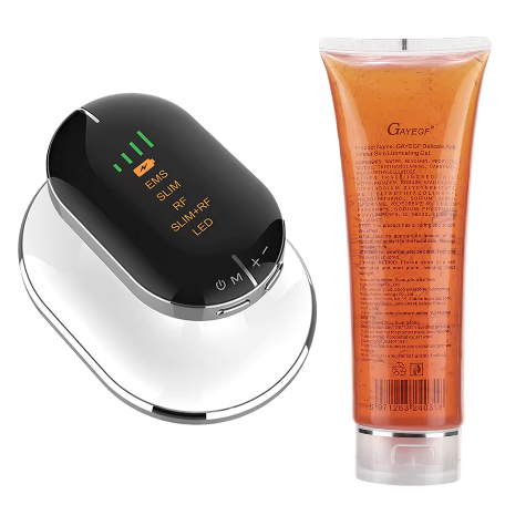 Black electronic device with digital display and orange tube of gel on a white background